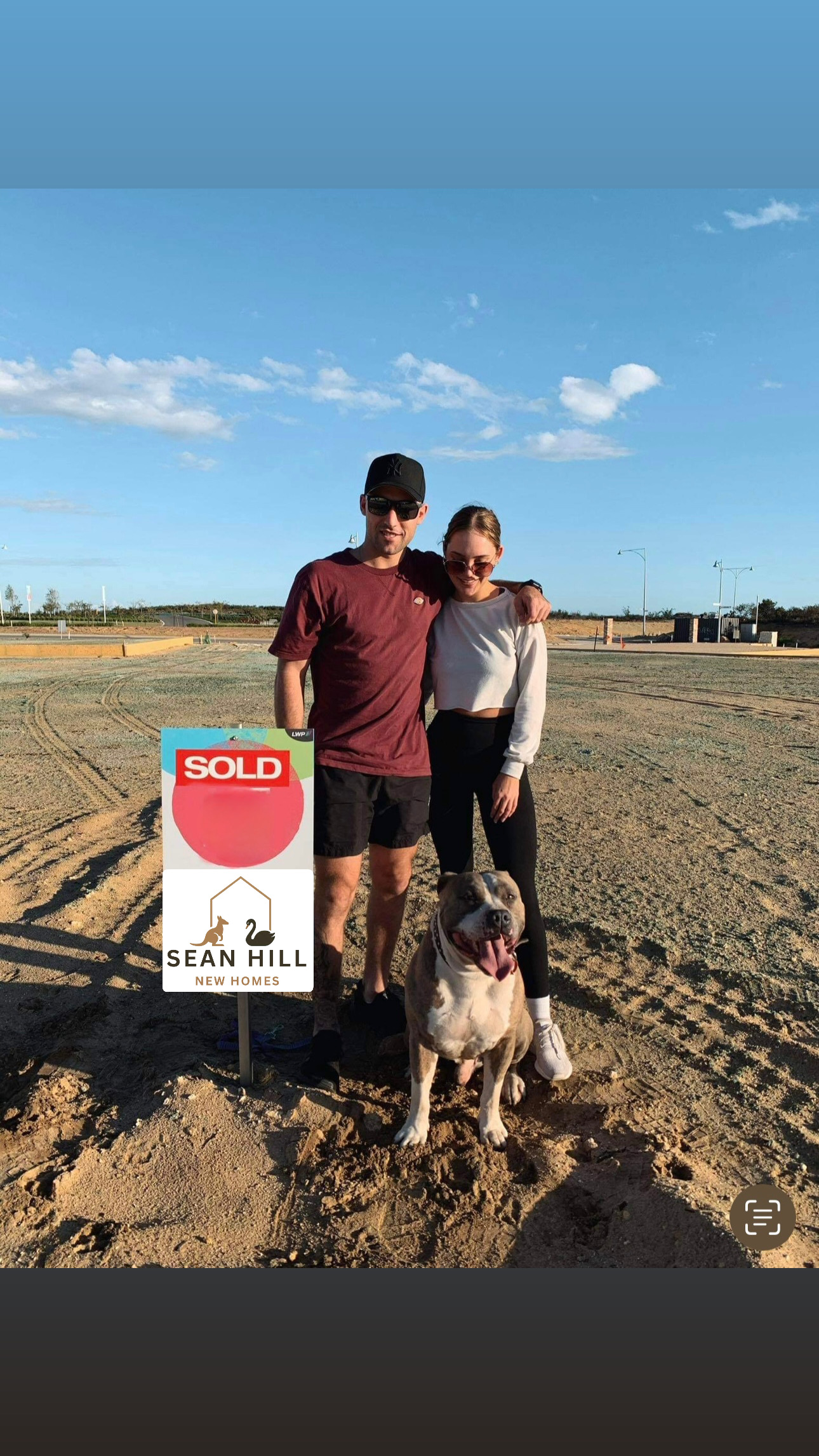 Couple with their dog celebrating land purchase