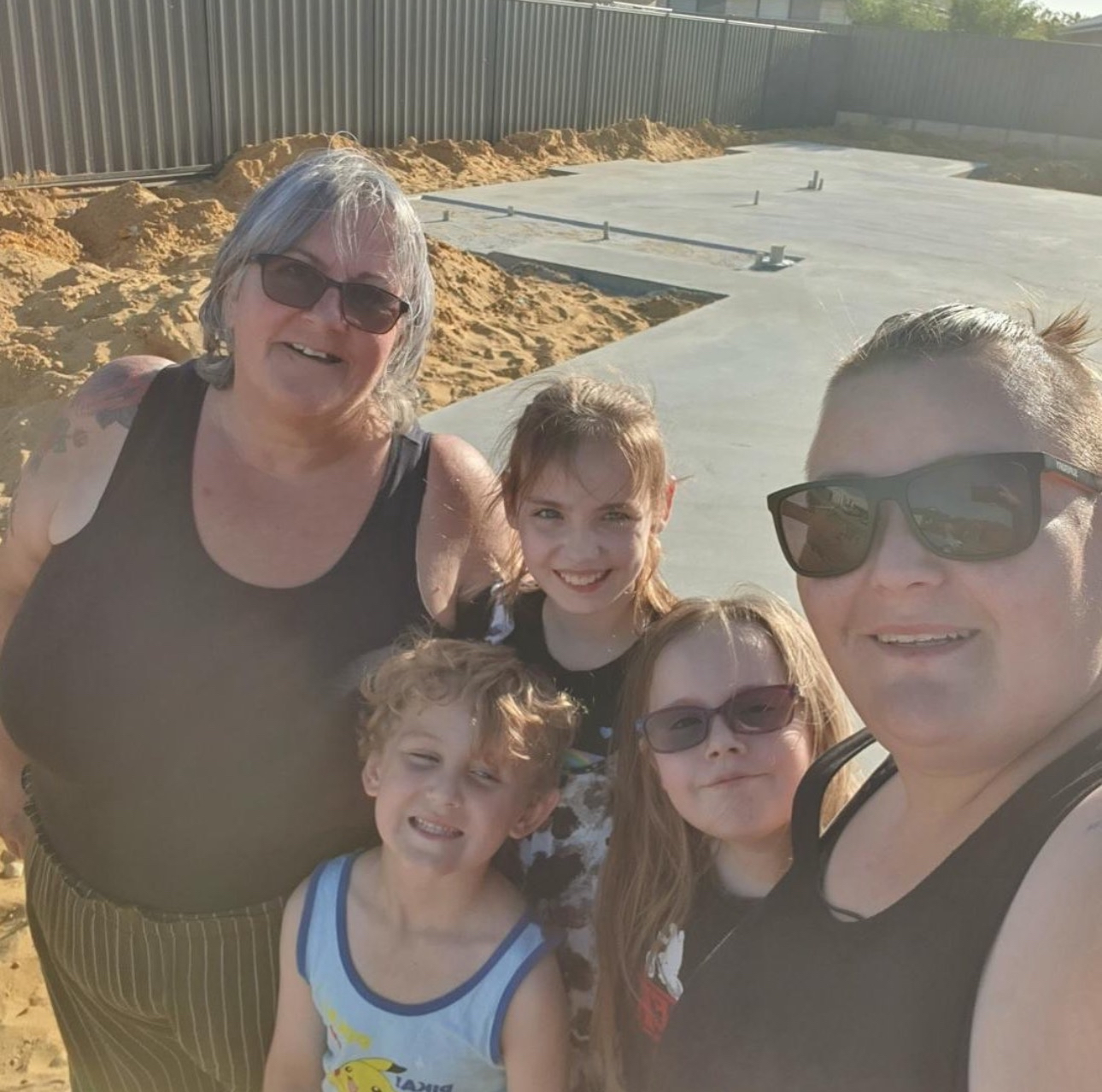 Family celebrating on their new home foundation