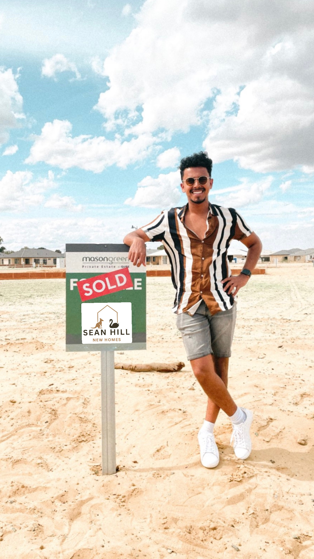 Sean with client and sold sign on building site